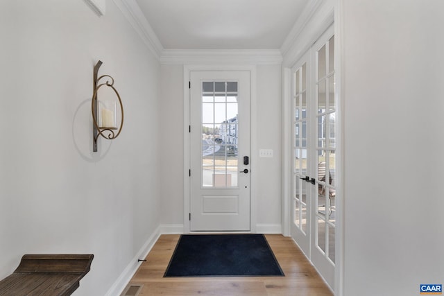 entryway featuring light hardwood / wood-style flooring, french doors, and ornamental molding