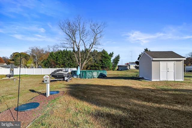 view of yard with a storage unit and a covered pool