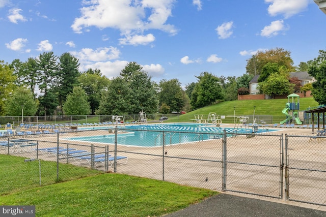 view of swimming pool featuring a yard and a patio