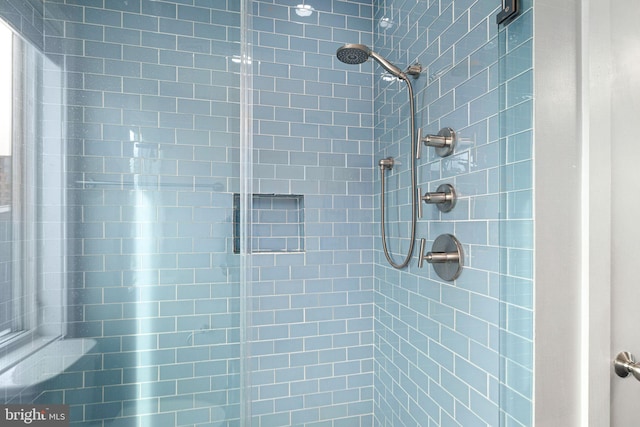 bathroom with a tile shower