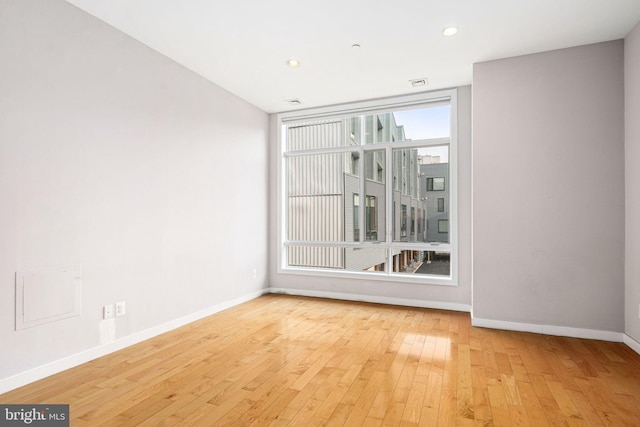 unfurnished room with light wood-type flooring