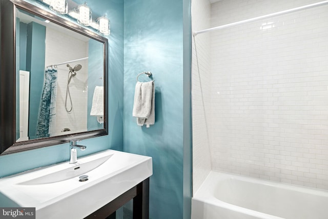 bathroom featuring shower / bath combination with curtain and sink