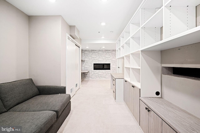 living room featuring light carpet and a stone fireplace