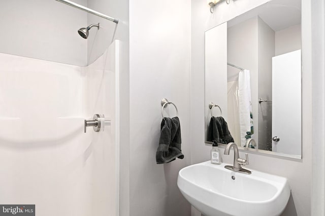 bathroom with sink and a shower with curtain