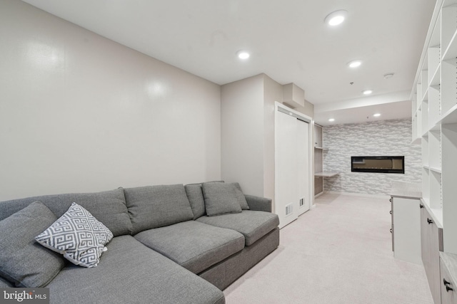 carpeted living room with a fireplace