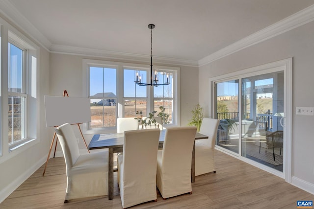 dining space featuring light wood-type flooring, a wealth of natural light, and a notable chandelier