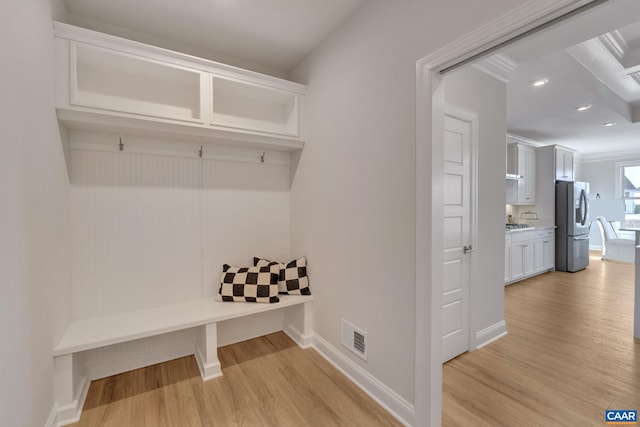 mudroom with light hardwood / wood-style flooring