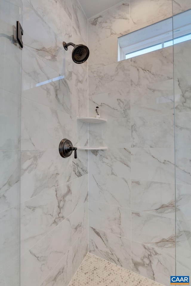 interior details with a tile shower