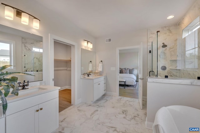 bathroom with vanity, an enclosed shower, and wood-type flooring