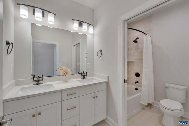 full bathroom with vanity, shower / bath combo, and toilet