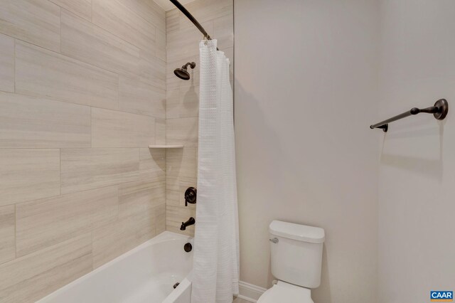 bathroom with shower / tub combo with curtain and toilet