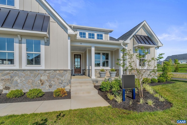 view of front of property with a porch and a front lawn