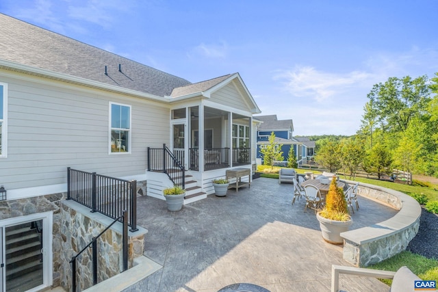 view of patio with a sunroom