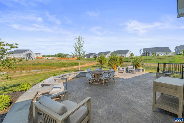 view of patio with outdoor lounge area and a water view