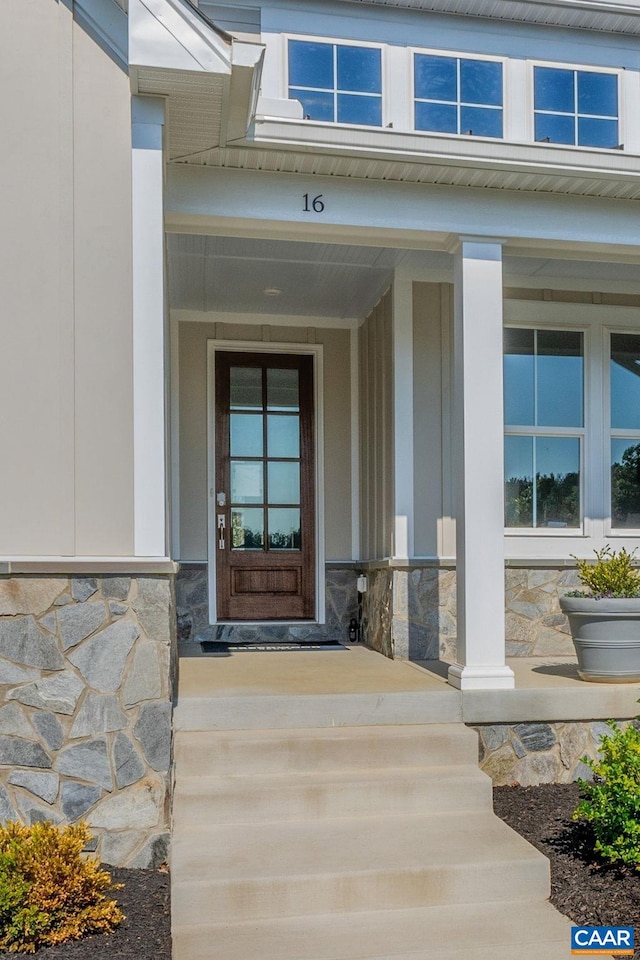 view of exterior entry with a porch