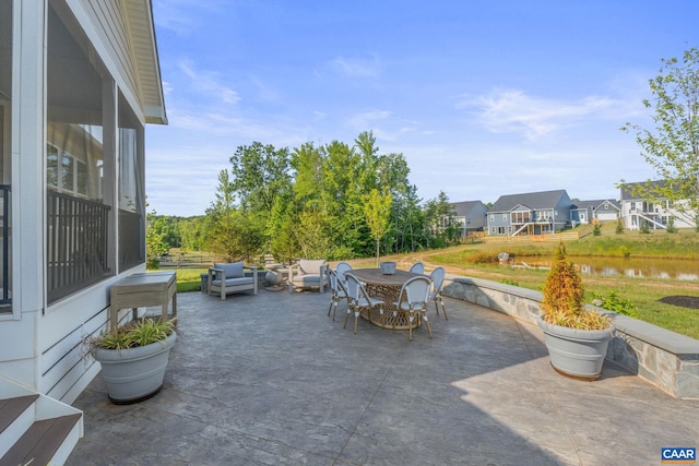 view of patio with an outdoor living space and a water view