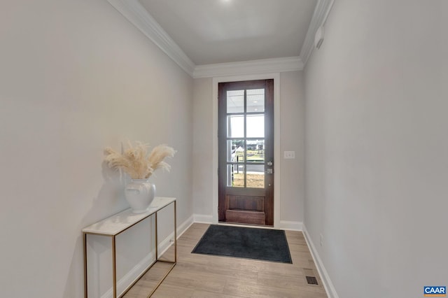 doorway to outside featuring ornamental molding and light hardwood / wood-style flooring