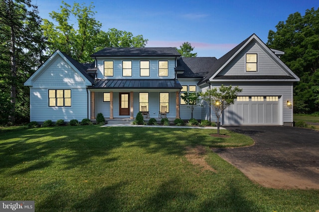 view of front of house with covered porch and a lawn