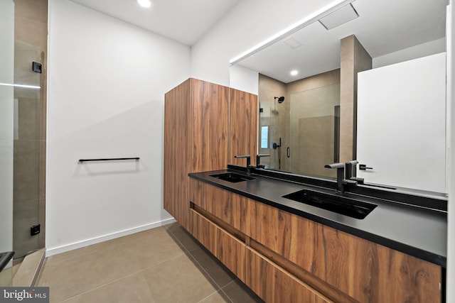 bathroom featuring vanity, tile patterned flooring, and a shower with door