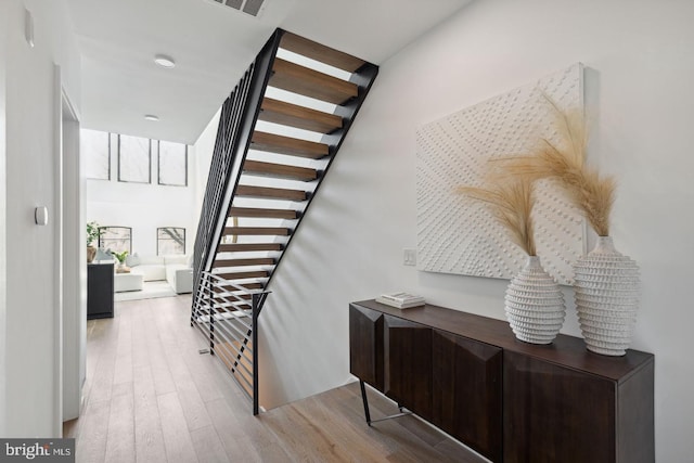 stairs with hardwood / wood-style floors