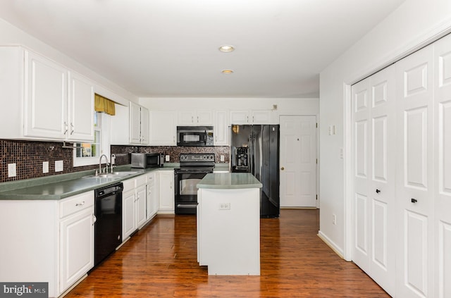 kitchen featuring white cabinetry, a center island, sink, dark hardwood / wood-style flooring, and black appliances