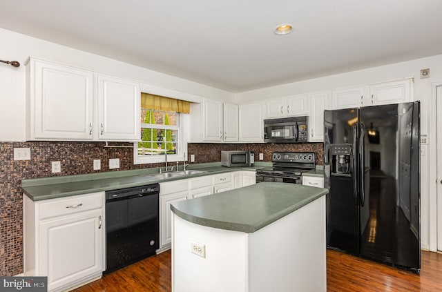 kitchen with sink, white cabinetry, a kitchen island, and black appliances