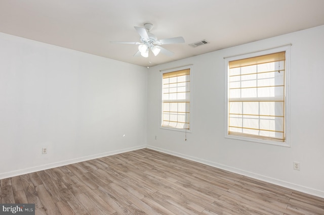 spare room featuring light wood-type flooring and ceiling fan