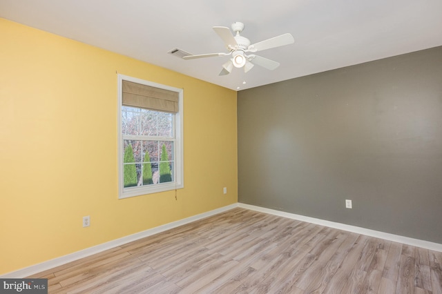 empty room with ceiling fan and light hardwood / wood-style floors