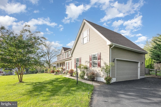 view of side of property featuring a lawn and a garage