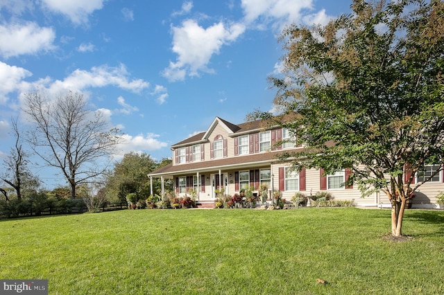 view of front of home featuring covered porch and a front lawn