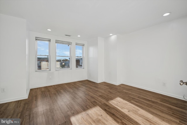 unfurnished room with wood-type flooring