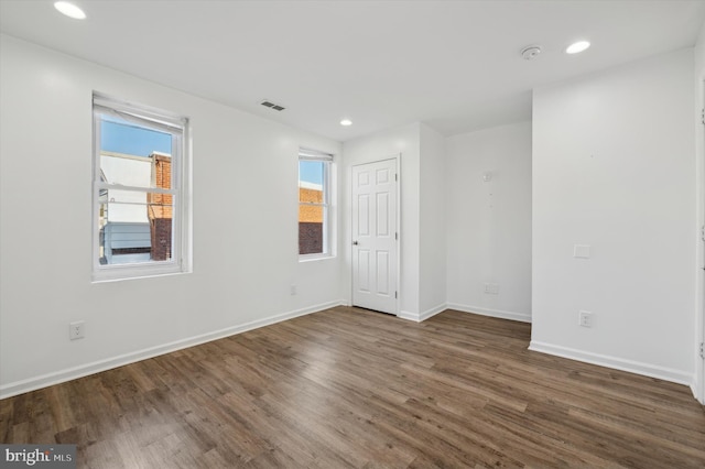 spare room with dark wood-type flooring