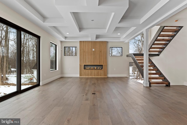 unfurnished living room featuring a fireplace and hardwood / wood-style flooring