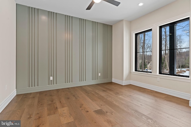 spare room featuring ceiling fan and light hardwood / wood-style flooring