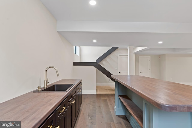 kitchen with a kitchen island, light hardwood / wood-style flooring, and sink