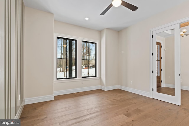 spare room with ceiling fan and light hardwood / wood-style flooring