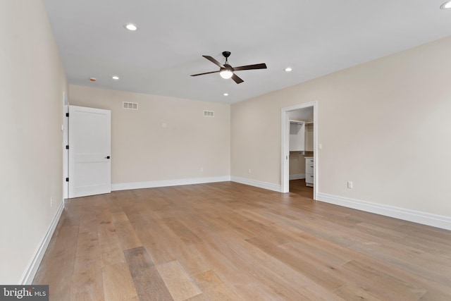 empty room featuring ceiling fan and light wood-type flooring