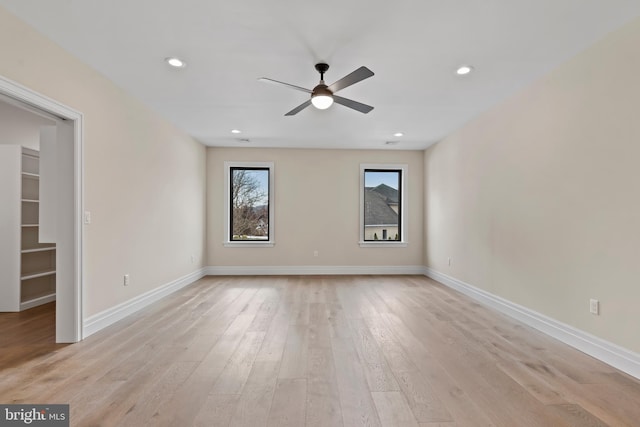 empty room featuring ceiling fan and light hardwood / wood-style flooring