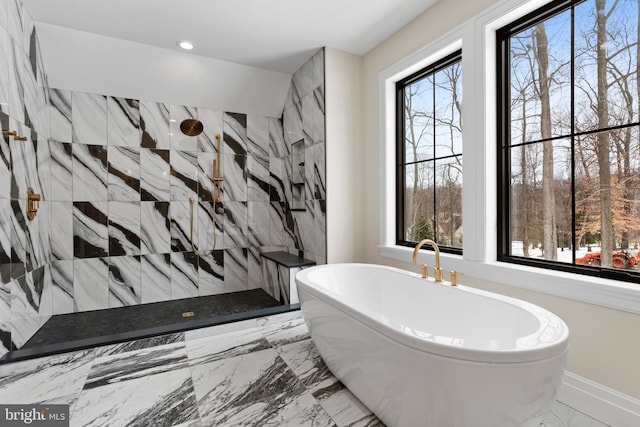 bathroom featuring shower with separate bathtub