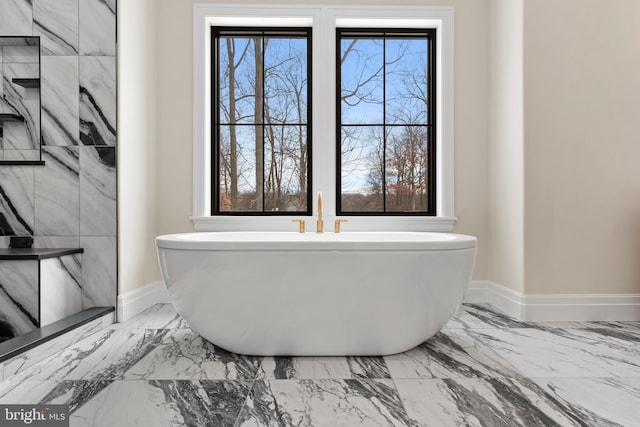 bathroom with a bathtub and a healthy amount of sunlight