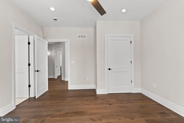 unfurnished bedroom featuring ceiling fan and dark hardwood / wood-style floors