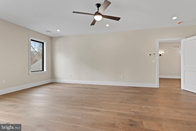 spare room with ceiling fan and light hardwood / wood-style flooring