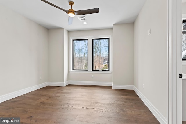 unfurnished room featuring ceiling fan and hardwood / wood-style flooring