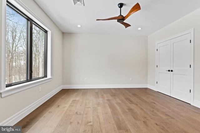 unfurnished bedroom with ceiling fan, a closet, and light hardwood / wood-style floors