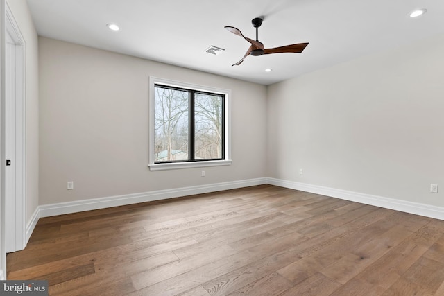 spare room with light hardwood / wood-style floors and ceiling fan