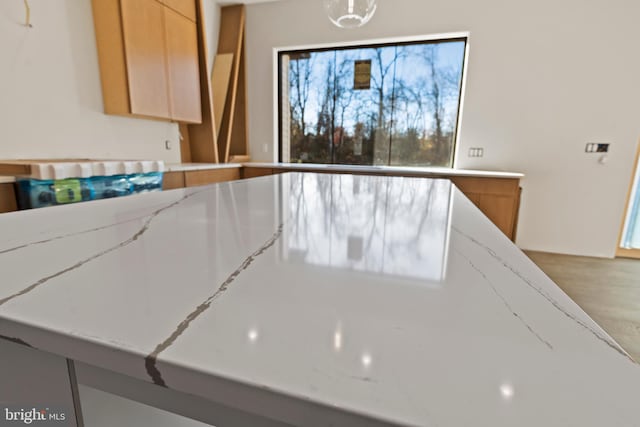 kitchen featuring light stone countertops and hardwood / wood-style floors