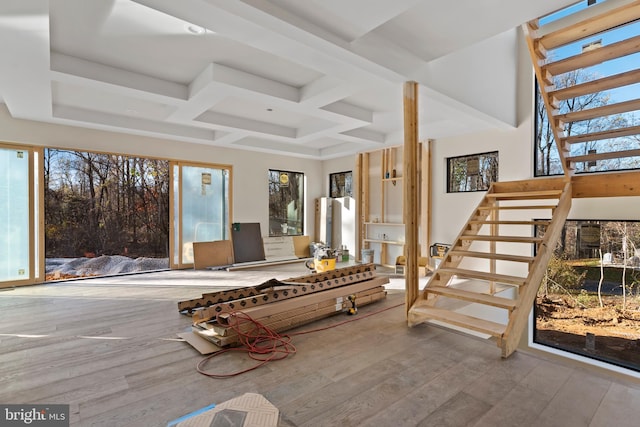 interior space with light hardwood / wood-style flooring and coffered ceiling