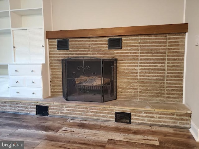 interior details featuring a fireplace and hardwood / wood-style floors