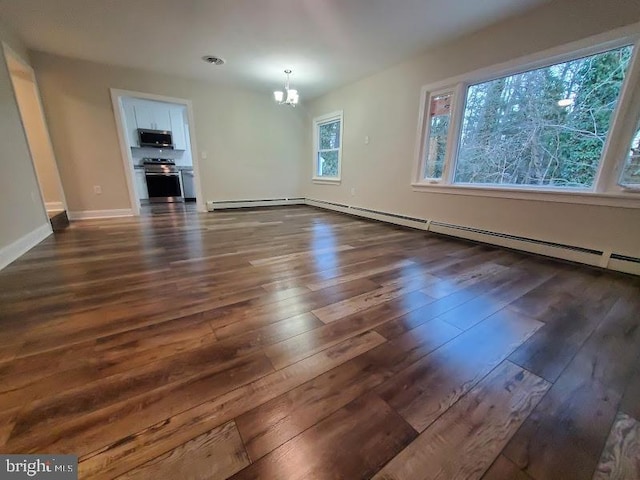 unfurnished living room with dark hardwood / wood-style floors, an inviting chandelier, and a baseboard heating unit