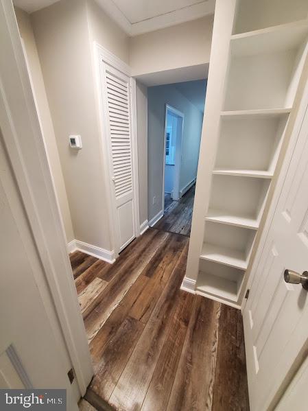 corridor featuring dark hardwood / wood-style floors